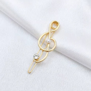 Spona do vlasů ve tvaru houslového klíče vyložená kamínkem zlatá barva